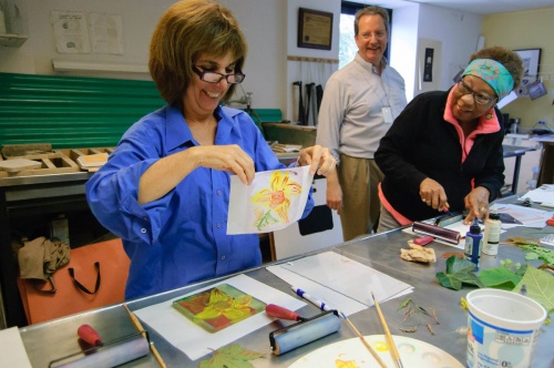 student sharing her print with classmates and instructor