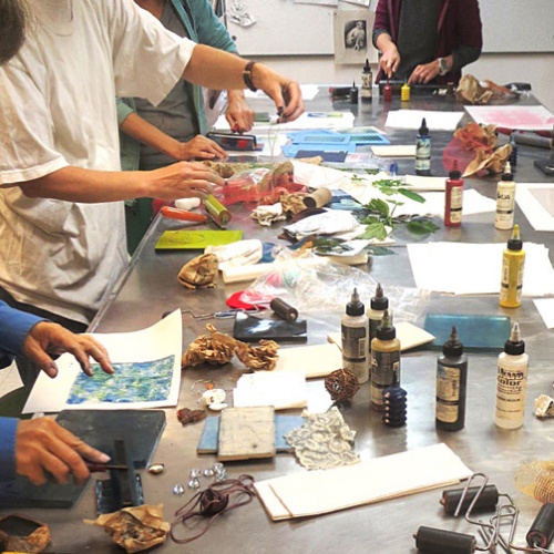 students printing by hand with ink and paper